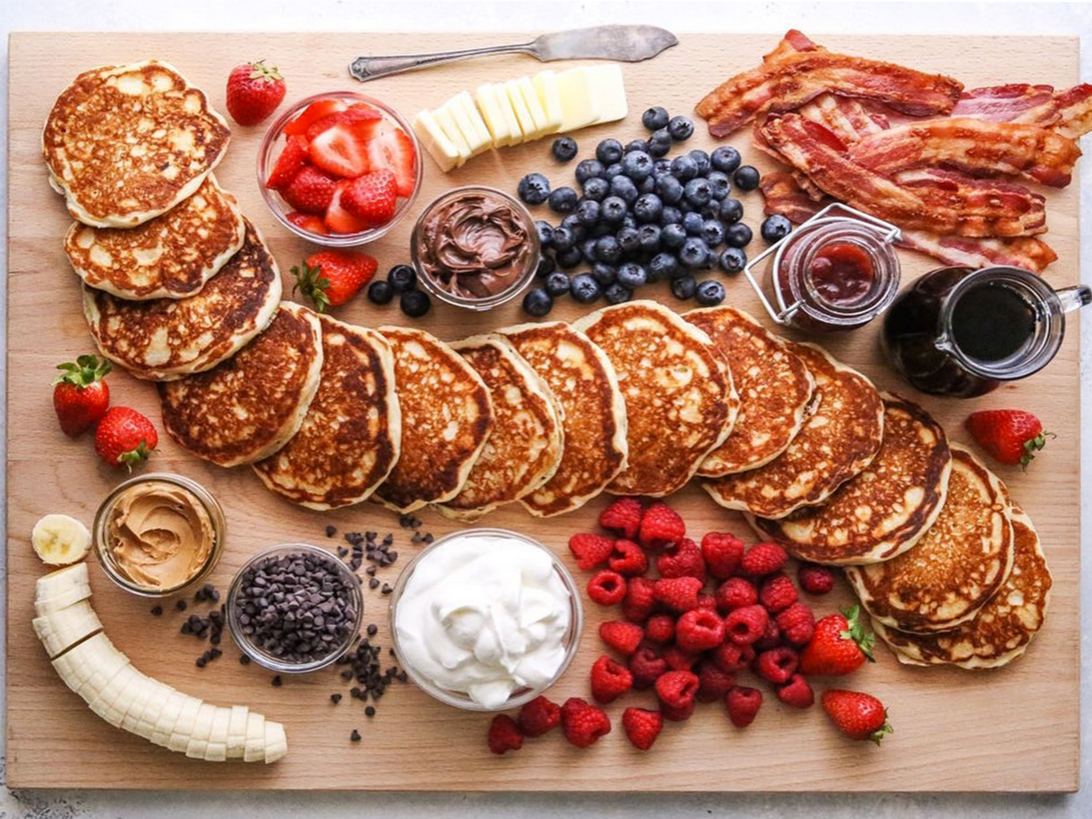 pancakes surronded by toppings